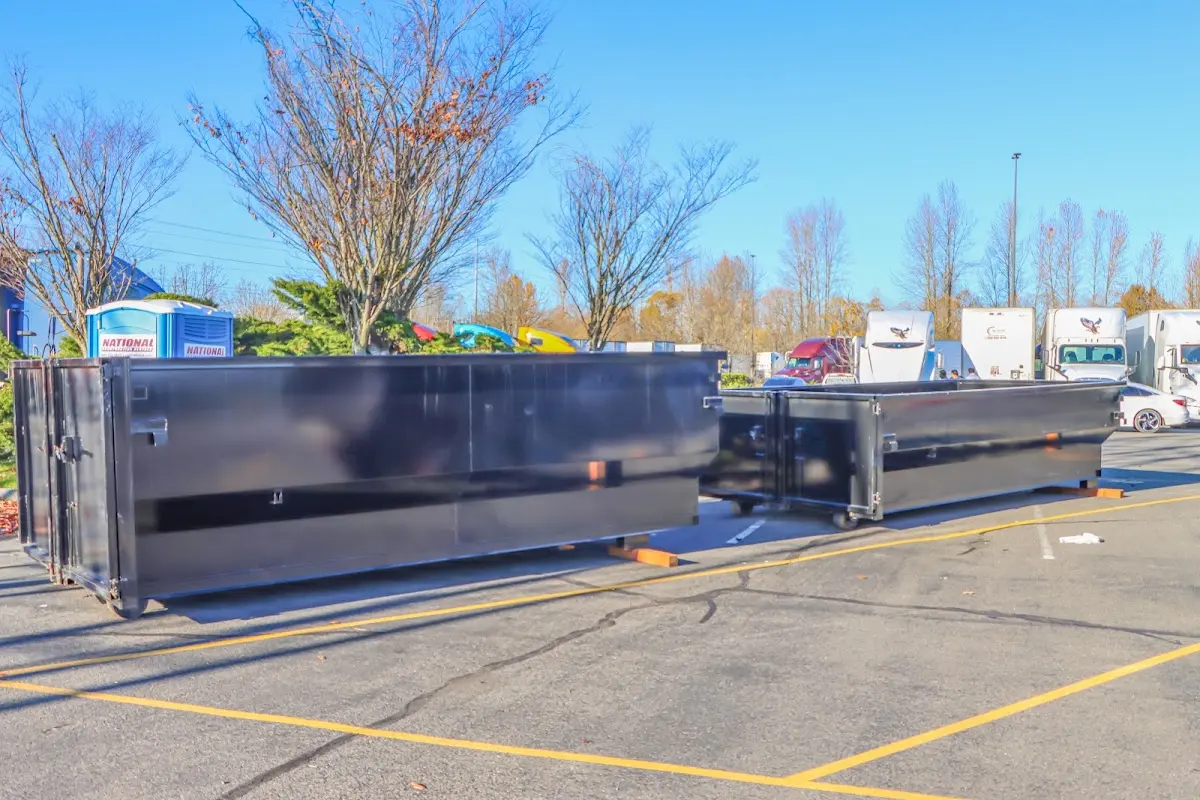 Professional dumpster rental service with roll-off container on residential driveway in Wildwood